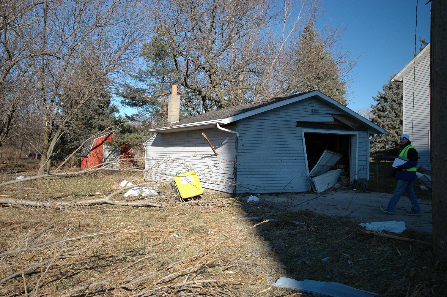 Garage damage with 2x4 thrown into side (Caledonia)
